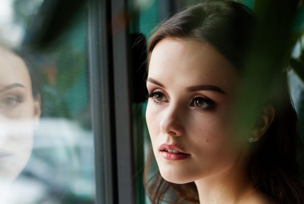 Woman looking through glass
