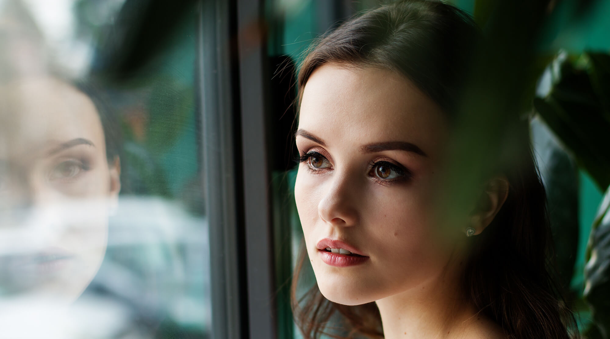 Woman looking through glass